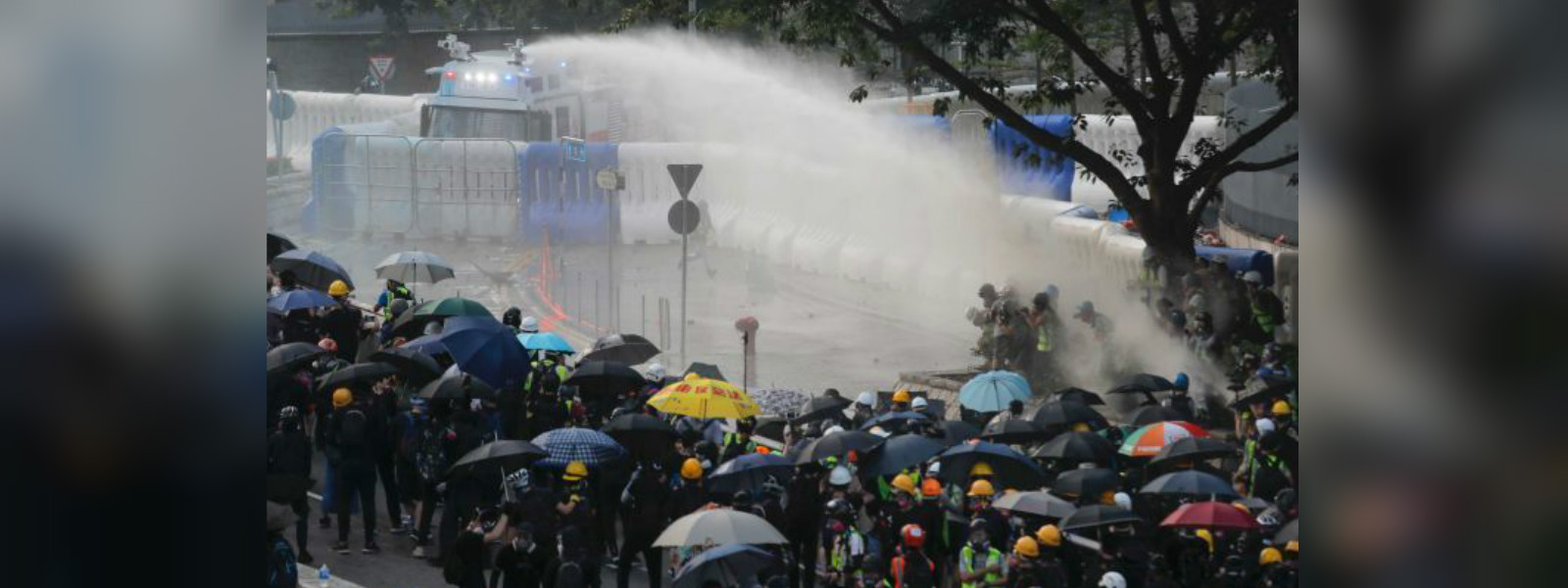 Hong Kong police fire water cannons at protesters