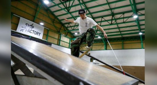 Blindskateboarder uses cane to ride the rails