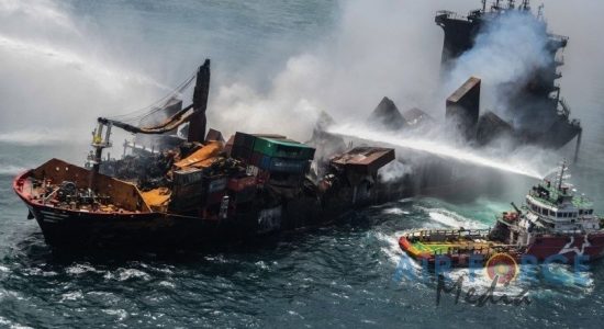 Divers to probe suspected leak in blazing ship