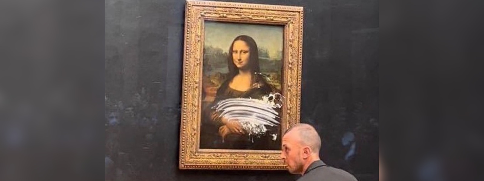 Man arrested after smearing Mona Lisa with cake